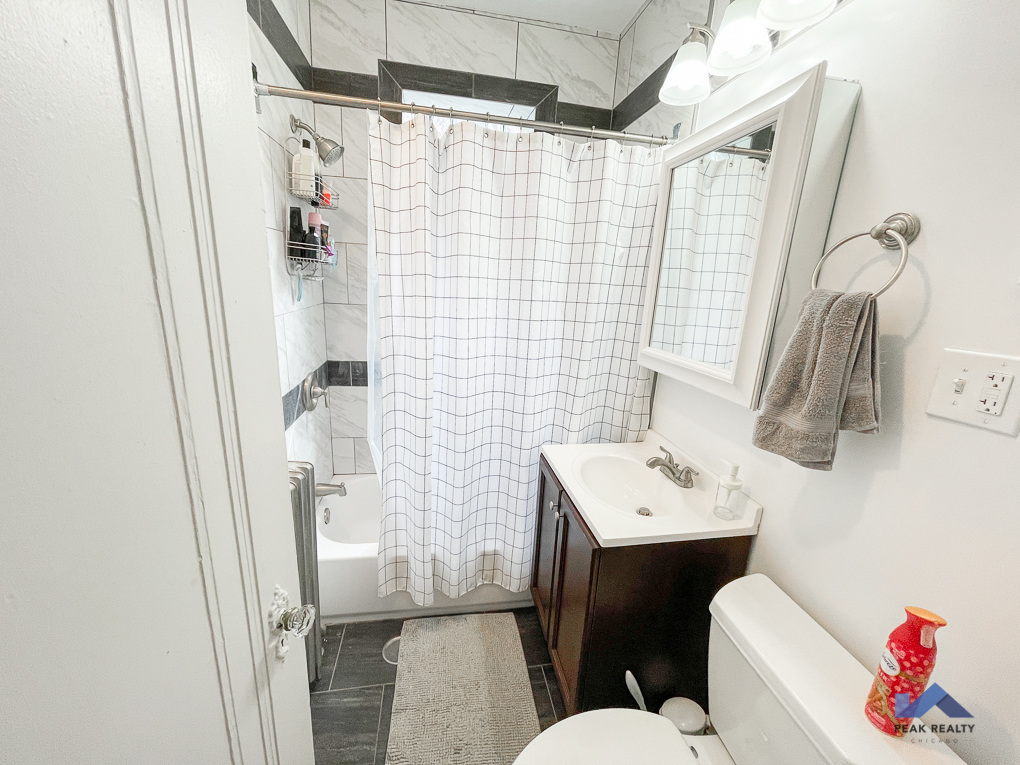 a small bathroom with a shower and a sink and a toilet